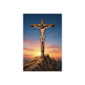 Statue of Jesus on the cross against a sunset sky