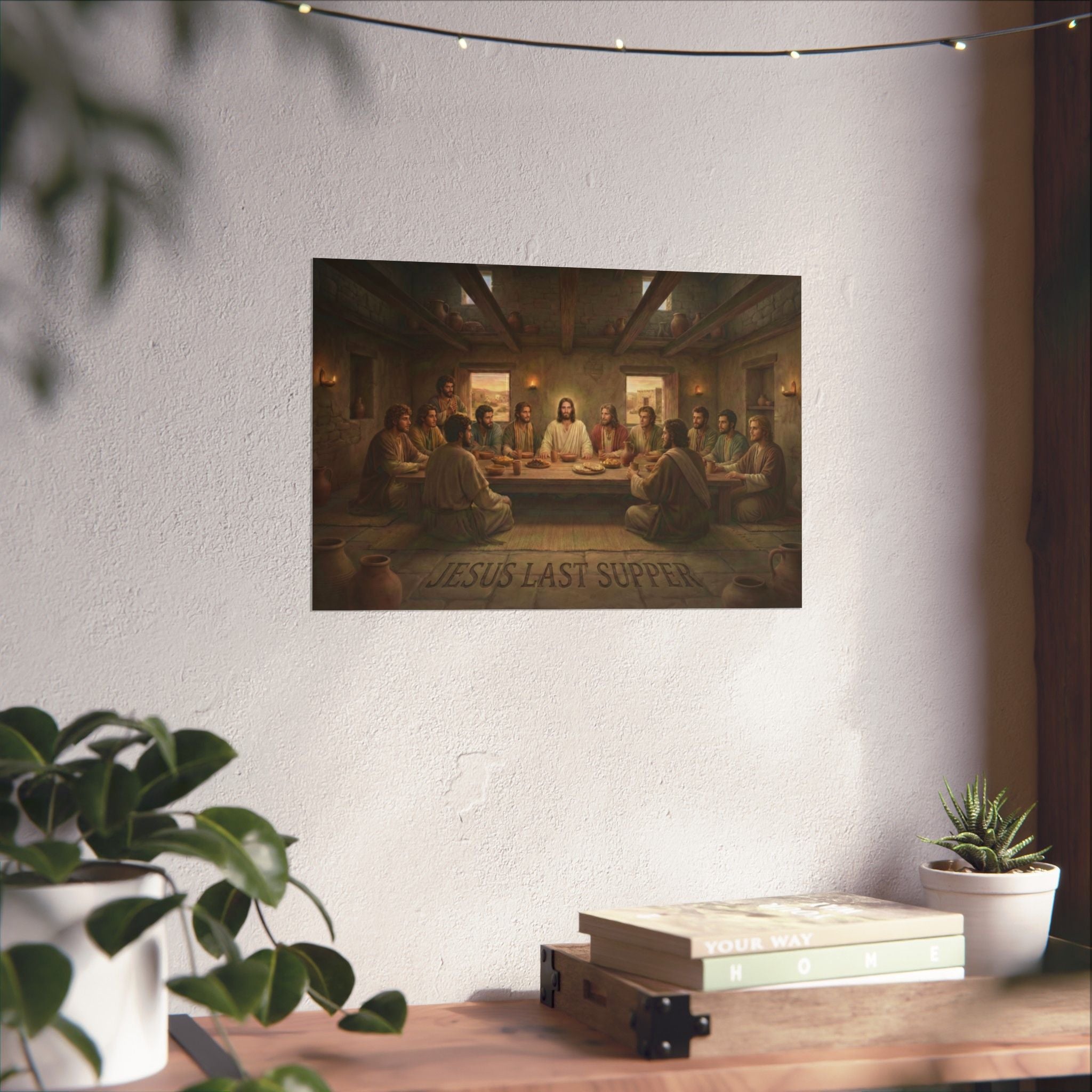 Poster of 'Jesus Last Supper' on a wall with plants and books in the foreground.