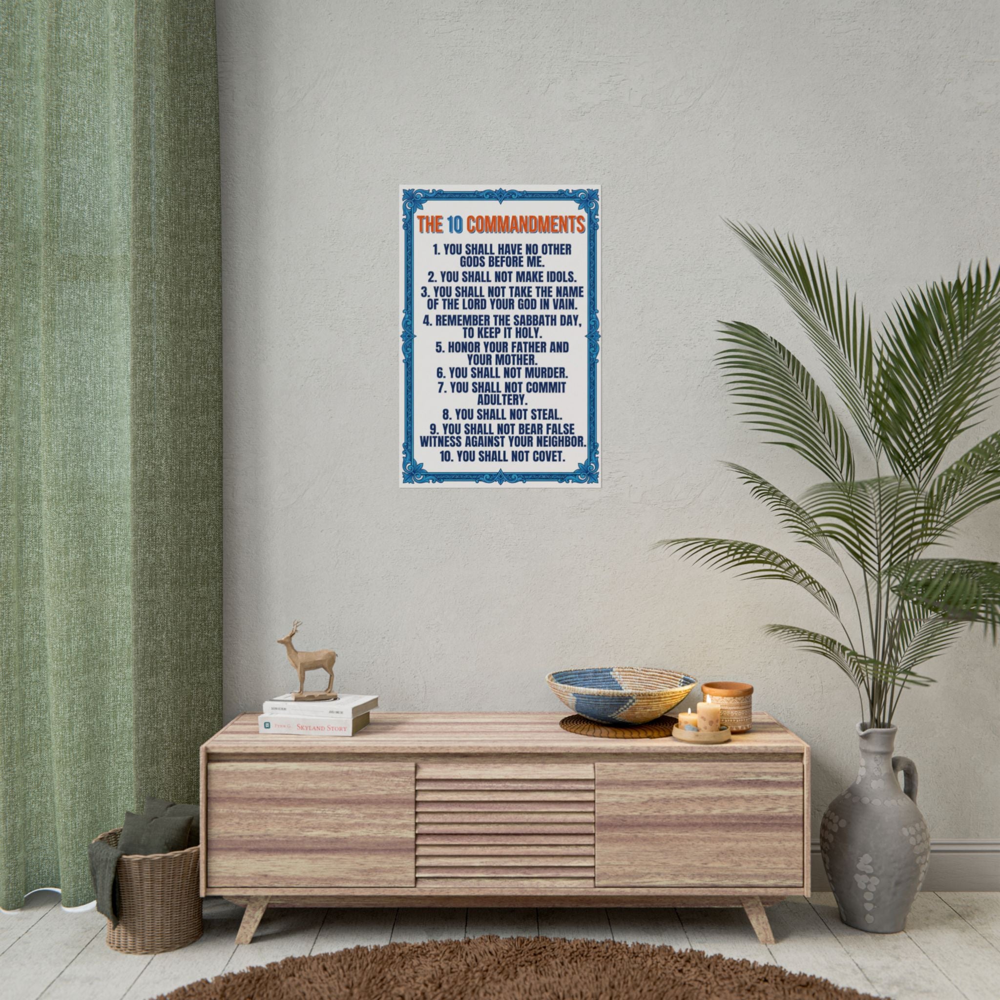 Poster of 'The Ten Commandments' on a wall above a wooden cabinet with decor items.